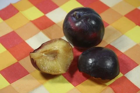 Plums on a chequered base Stock Photos
