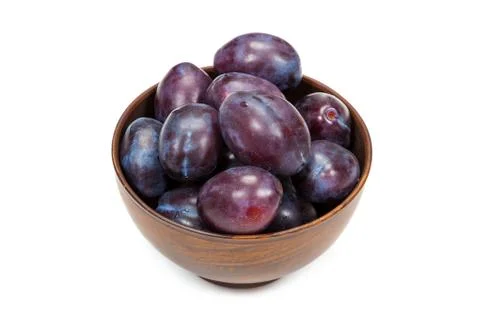 Plums in an earthenware dish on white background Stock Photos
