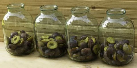 Plums placed in jars - Plum compote in the cooking process Stock Photos