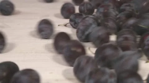 Plums tipped on a chopping board Stock Footage 24673353
