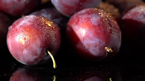 Plums with water drops on black background Stockbeeldmateriaal 163956911