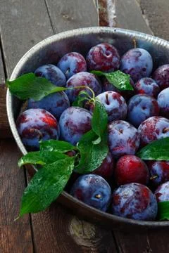 Plums on a wooden table Stock Photos