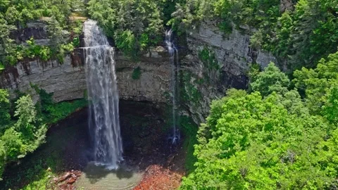 Plunge Falls: Towering Waterfall within a Deep, Green-Lined Gorge 4K Video 動画素材 320544640