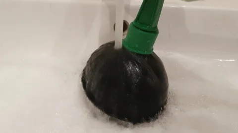Plunger trying to remove clogged sinks Video stock 87511117