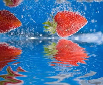 Plunging Strawberries Stock Photos