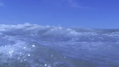 Plunging into the waves, fast air bubbles rising Stock Footage 83483297
