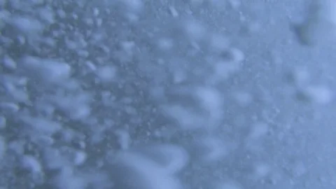 Plunging into the waves, fast air bubbles rising Stock Footage 83485419
