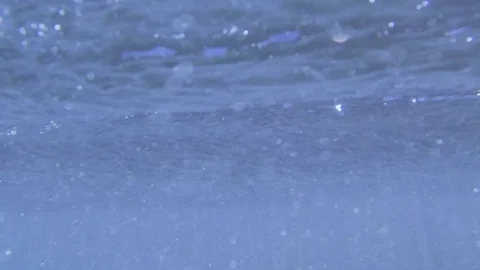 Plunging into the waves, fast air bubbles rising Stock Footage 83486167