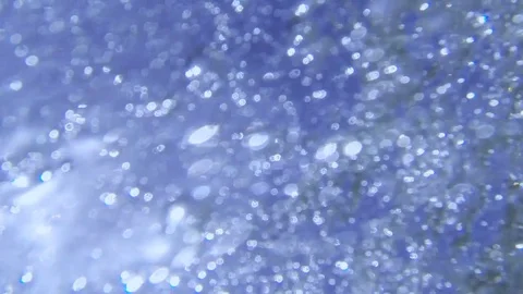 Plunging into the waves, fast air bubbles rising Stock Footage 83487596