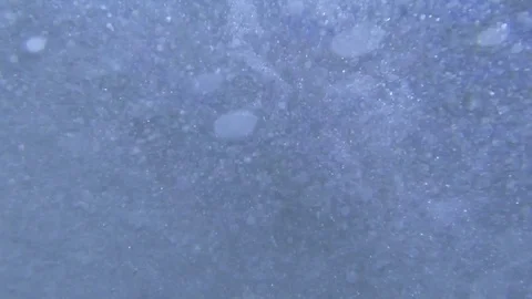 Plunging into the waves, fast air bubbles rising Stock Footage 83488181