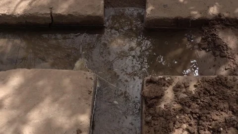 A plus shape is carved into the ground to distribute water that turns to the Vídeo Stock 321945483