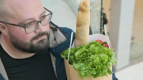 Plus size Caucasian bearded man in glasses standing on escalator carrying Stock Footage 263823922