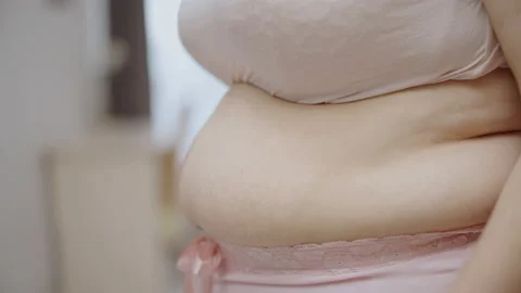 Plus size female touching excessive abdominal fat feeling unhappy, insecurities Vidéo 149316649