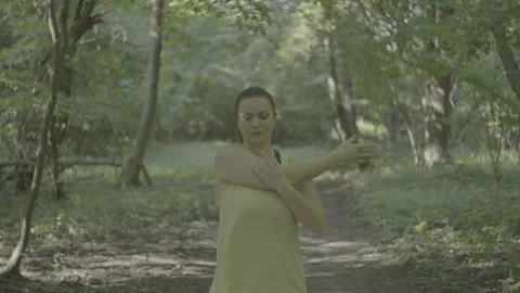 Plus size girl is getting ready and warming up before jogging in the park Stock Footage 248217706
