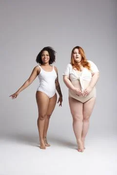 Plus size girls posing for camera in studio Stock Photos