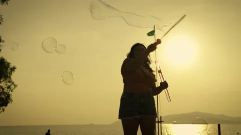 Plus size ladies having fun playing bubbles in the evening atmosphere. Stock Footage 221800743