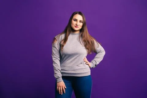 Plus size model in casual clothes, fat woman on purple background Stock Photos