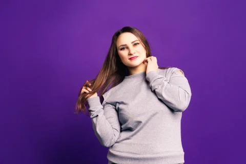 Plus size model in casual clothes, fat woman on purple background Stock Photos