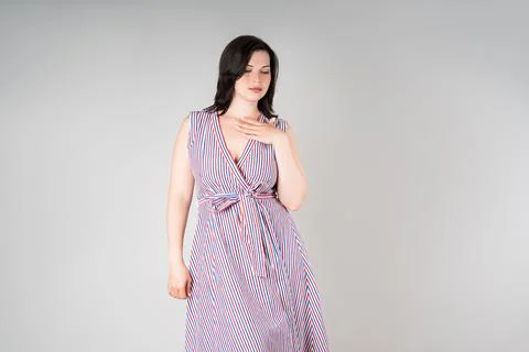 Plus size model in casual clothes, fat woman on gray studio background, overw Stock Photos