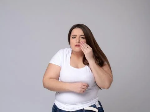 Plus Size Model with a hand holding a sore tooth Stock Photos
