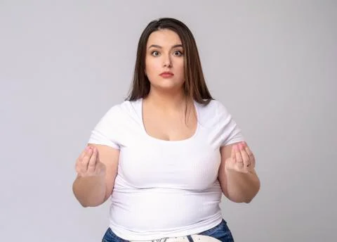 Plus Size Model with long hair meditates in studio. Stock Photos