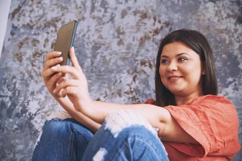 Plus size model making selfie via her smartphone Stock Photos