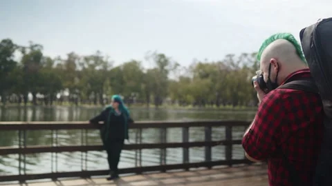 Plus size model posing while a photographer take photos of her at park Stock-Footage 139365234
