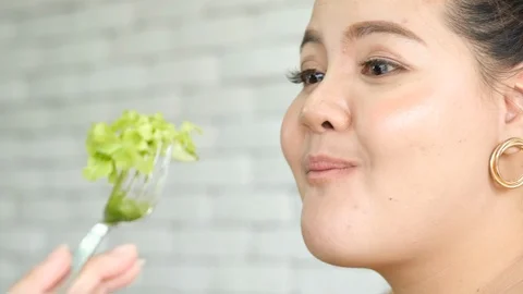 Plus size or big size girl enjoys eating vegetable salad and happy Stock Footage 120717359