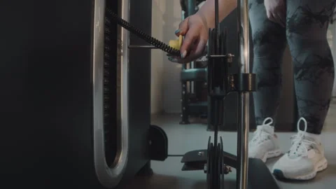 Plus Size Woman Adding Weight Bars on Gym Machine Stock Footage 277203187