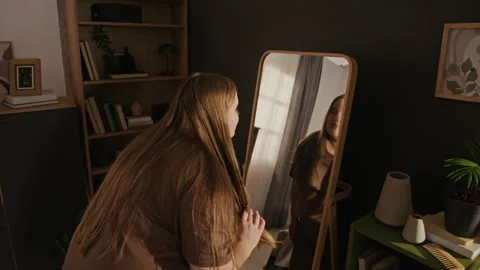 Plus Size Woman Looking in Mirror Admiring Her Body with Smile Stock Footage 337905436