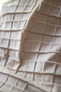 Plush beige fabric texture with geometric quilted pattern Stock-Fotos