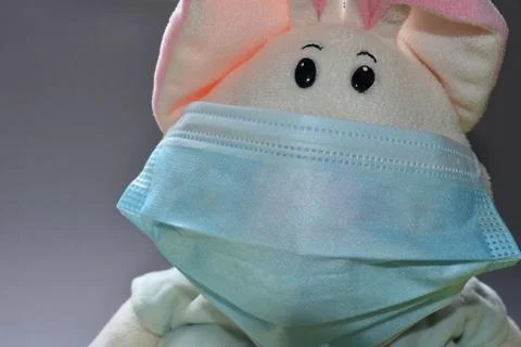 A plush hare in a mask. Stock Photos