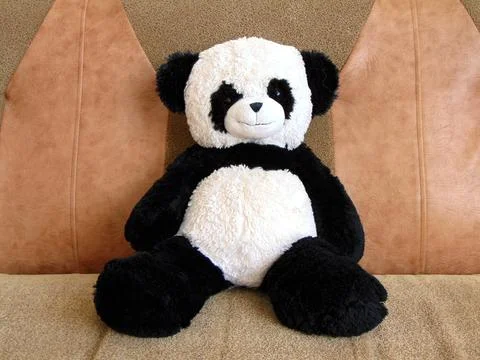 Plush panda bear on a sofa Stock-Fotos