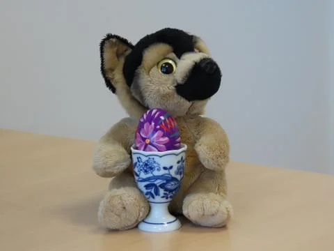Plush puppy with egg Stock Photos