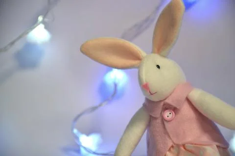 Plush rabbit on a gray background. New year 2023. Stock Photos