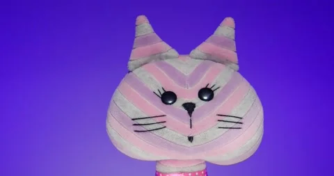 Plush Toy Poses in front of the Camera Lens on a Colorful Background. Stock Footage 148243456
