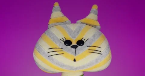 Plush Toy Poses in front of the Camera Lens on a Colorful Background. Stock Footage 148243460