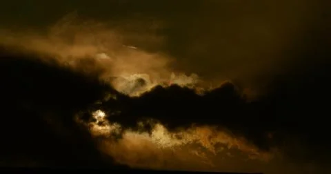 Plutonium enriched cloudscape backlit by an apocalyptic sun. Stock Photos