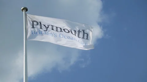 PLYMOUTH, UK - Plymouth "Britain's Ocean City" flag flies on the Plymouth Hoe Stock Footage