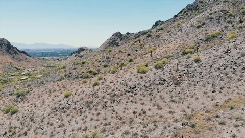 PMP415a_View of a hill flying left, rotating right revealing town underneath Stock Footage 116534852