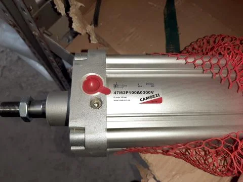 Pneumatic Cylinder Displayed on a Workbench With Protective Mesh Covering Stock Photos