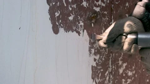 Pneumatic hammer beats pieces of old paint off the wall. Stock Footage 219971003