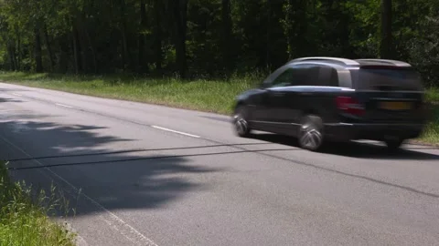 Pneumatic road tubes traffic count system across the road  3 vehicles passing by Video stock 243068724