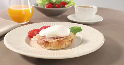 Poached egg with bacon on a plate. boiled egg on bread with sauce. Stock Footage 241082374