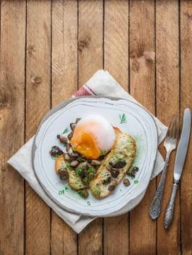 Poached egg with bread and wild mushrooms, copy space Stock Photos