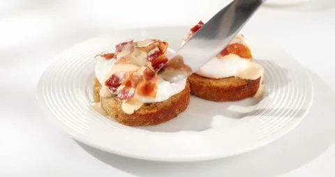Poached egg cuts with knife. poached egg toast. sunny day. angle view. Stock Footage 242042121