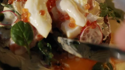 Poached egg with red caviar on cooked spinach leaves and salmon sandwich 스톡 동영상 151296791