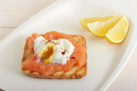 Poached egg with salmon on bread Stock Photos