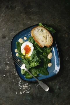Poached egg with spinach Stock Photos
