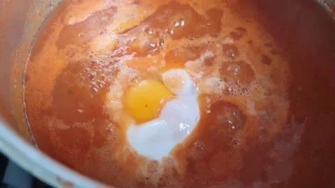 Poached egg in tomato sauce Stock Footage 233352769